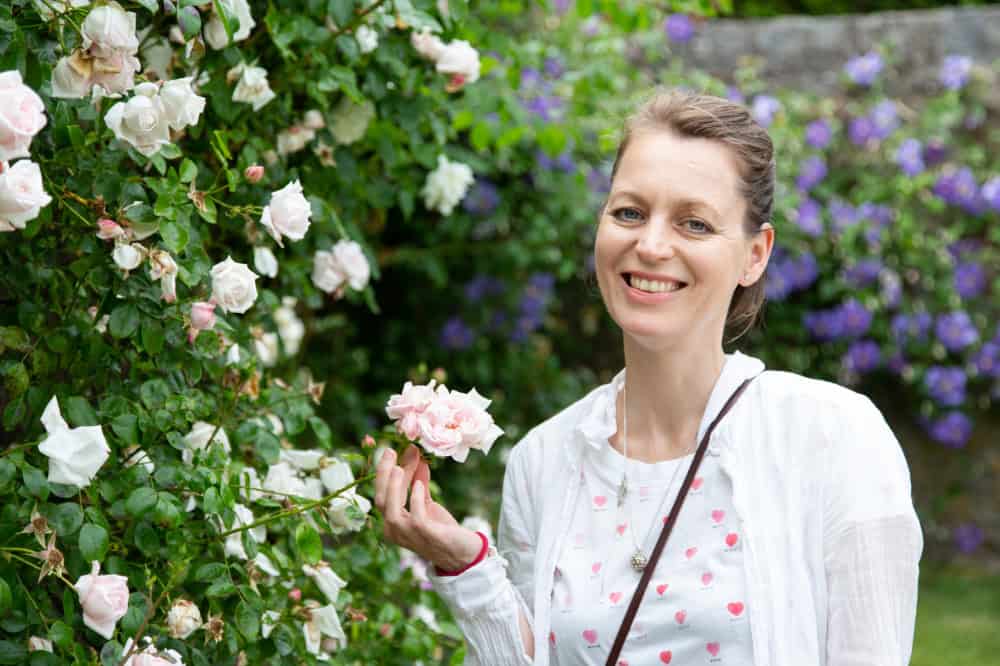 A photo of Laura Hoy with roses - aromatherapy workshop