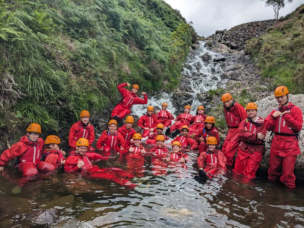 A photo of young people in a river Ghyll scrambling - Adventure+ Camp