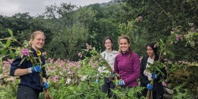 A photo of young people stood surrounded by plants - +Adventure Camp